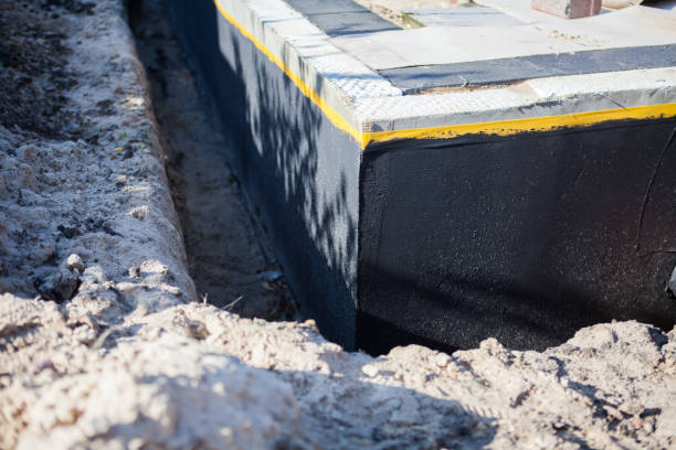 Professional Waterproofing technician working in Bath, MI